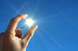 Hand sun and blue sky