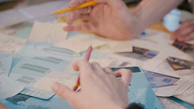Teamwork and ideas, hands of business colleagues working together, writing ideas on paper at office meeting close-up.