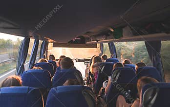 tour on the bus. People travel by bus. Salon of the great tourist bus with people at sunset