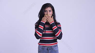 Young beautiful Persian woman showing speak no evil concept