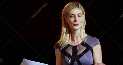 Young blonde Caucasian businesswoman speaking in business seminar at auditorium 4k