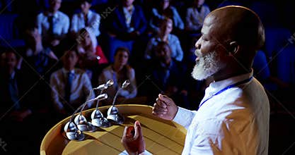 African American businessman speaking in business seminar in auditorium 4k