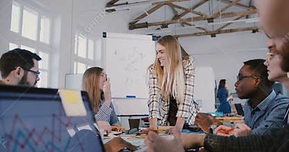 Successful attractive Caucasian businesswoman leading creative multiethnic employees at office brainstorm team meeting.