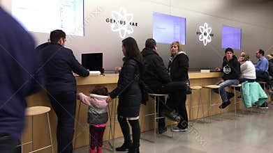 Motion of people talking to the worker at genius bar inside apple store