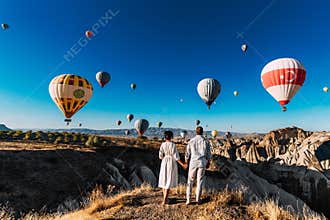 Wedding travel. Honeymoon trip. Couple in love among balloons. A guy proposes to a girl. Couple in love in Cappadocia. Couple in