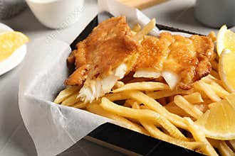 Container with British traditional fish and potato chips