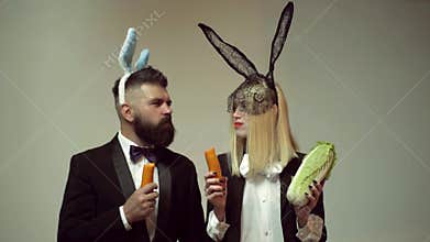 Funny easter bunny. Happy funny easter couple with carrot. Family celebrate Easter. Easter rabbits. Couple with bunny