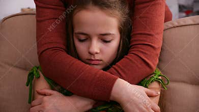 Woman hands hug young worried girl offering support