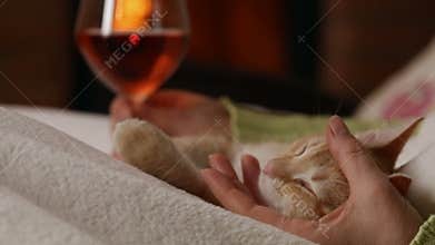 Woman enjoy a glass of wine at the fireplace