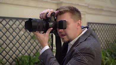 Professional photo shooting indoors. Photographer is taking pictures photos with a digital camera DSLR.