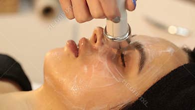 Rejuvenating facial treatment. Model getting lifting therapy massage in a beauty SPA salon. Exfoliation, Rejuvenation