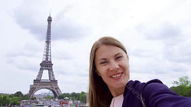 Woman near Eiffel Tower using mobile talking via messenger app. Smiling tourist woman traveling in Europe.