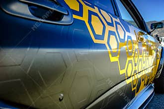 Pasting of car with carbonic vinyl wrap closeup