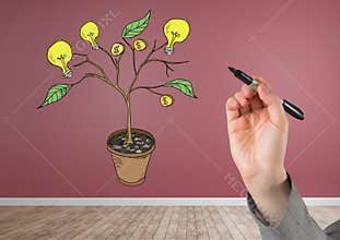 Hand holding pen and Drawing of Money and idea graphics on plant branches on wall