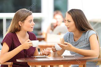 Serious friends talking in a restaurant