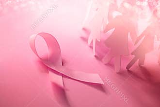 The Sweet pink ribbon shape with girl paper doll on pink background for Breast Cancer Awareness symbol to promote in october mo