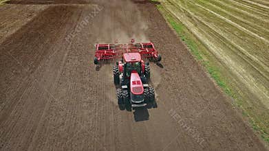 Agriculture machinery. Agricultural tractor plowing farming field