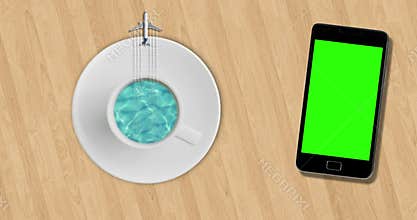 Blue sea ocean on sunny day into coffee cup and tourism airplane fly on it on wood table near smartphone with chroma key green