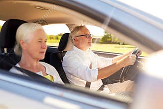 Happy senior couple driving in car
