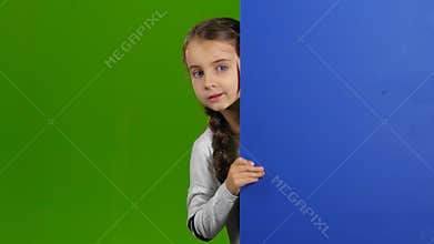Baby looks out from behind an empty board. Green screen
