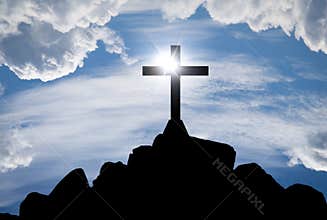 Cross silhouette on the hill