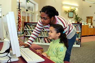 Child on Computer With Teacher