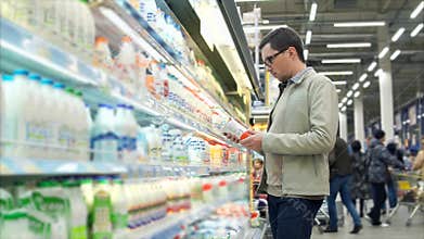 Man buying dairy products in the supermarket