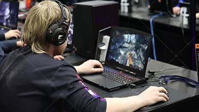 Gamers streamers playing video games on laptops on Igromir Games World and Comic Con Russia 2017 in Moscow, Russia