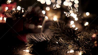 Christmas gift boxes decoration on Santa hat with tree and bokeh lights