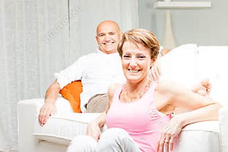 Happy married couple relaxing at home together
