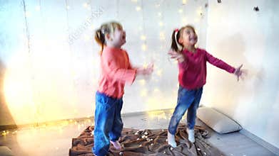 Two kids dancing at home christmas party