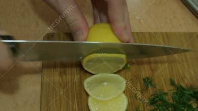 Male hands slicing lemon. Russian cuisine.