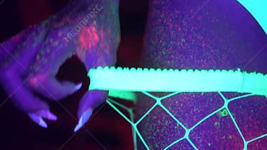 woman with UV fluorescent face and body makeup
