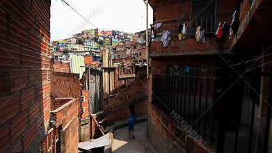 Girl walks in poor neighborhood in Latin America
