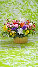 Multicolored flowers bouquet on green, marble stylised background
