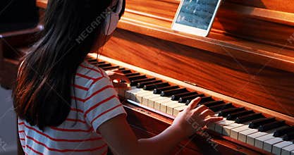 Schoolgirl learning piano in music class 4k