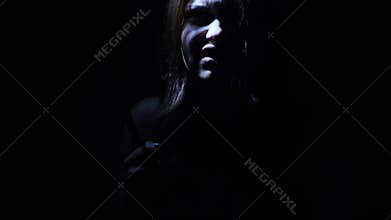 Portrait of a horror Halloween Scream inspired teen girl with a knife