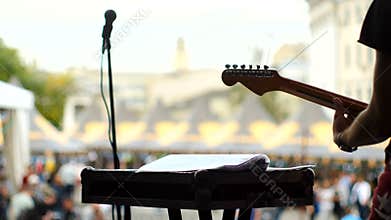 The guitarist plays at the concert.
