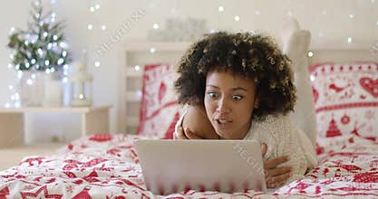 Beautiful Afro American girl lying on bed