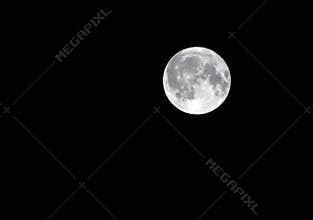 Silver full harvest moon in a dark black sky