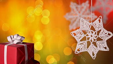 Christmas present and crocheted xmas decorations against blurry background