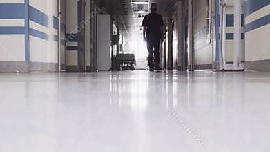 Doctor Walking through the Dark Hallway