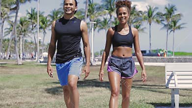 Smiling couple exercising with legs up