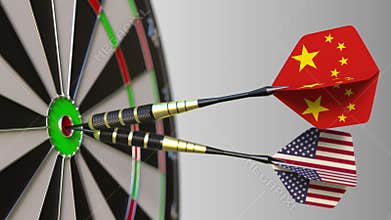 Flags of China and the USA on darts hitting bullseye of the target. International cooperation or competition conceptual