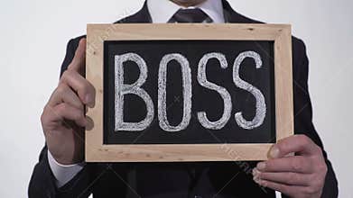 Boss written on blackboard in businessman hands, corporation top manager, leader