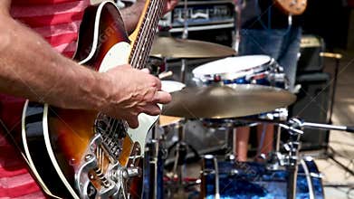 Guitarist playing in a band on sunny day
