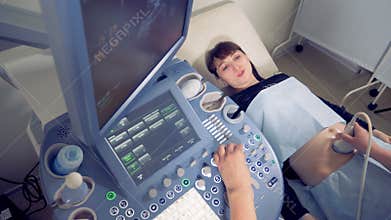Top view of a young pregnant woman undergoing ultrasound