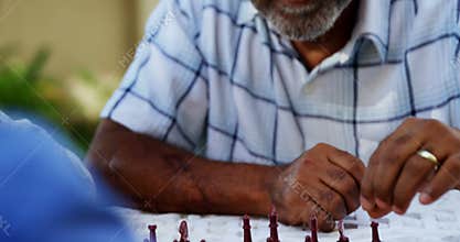 Senior friends playing chess 4k