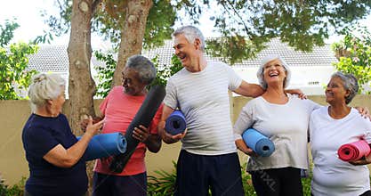 Smiling senior friends holding exercise mat and interacting with each other 4k