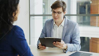 HR male manager shaking hand to female candidate after having job interview in modern office
